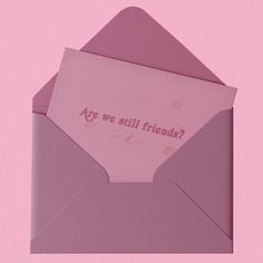 an open pink envelope with the words are we still friends?