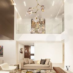 a living room filled with lots of furniture and a chandelier hanging from the ceiling