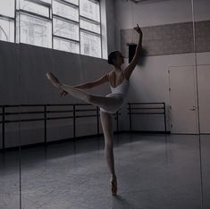 a ballerina standing in the middle of an empty room