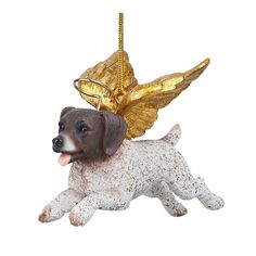 a brown and white dog ornament hanging from a gold colored chain with angel wings