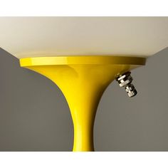 a yellow table lamp with two black knobs on it