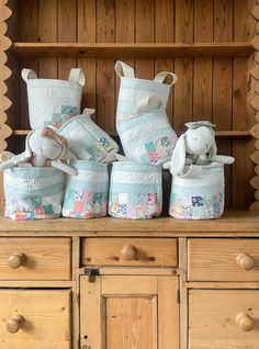 several baskets are stacked on top of each other in front of a wooden hutch