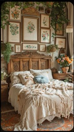 a bed sitting in a bedroom next to pictures on the wall and plants hanging above it