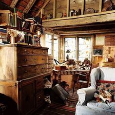 a living room filled with furniture and lots of clutter