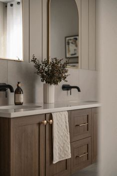 a bathroom sink with a mirror above it and a towel hanging on the wall next to it