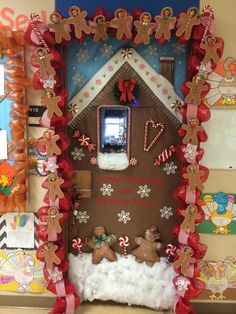 a gingerbread house decorated for christmas with candy canes and candies on the door