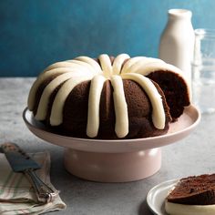 a bundt cake with white icing on a plate