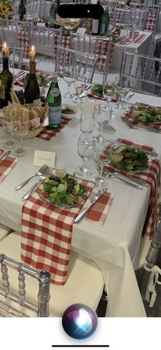 the table is set with wine glasses, plates and silverware for an elegant dinner