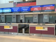 there are many electronic screens in this airport terminal that show the time and times for boarding passengers