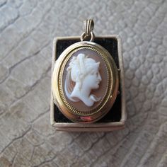 Antique 14k Yellow Gold Cameo Oval Locket Pendant Keepsake. Victorian 19th Century Hand Carved Cameo Pendant. Neoclassic Fine Gold Jewelry, hallmarked on bale, front and back, antique in age, Victorian Era, good overall condition, as shown.  18 MM or 3/4 IN x 24 MM or 15/16 IN, oval locket measurement, bale not included in measurement  6.0 grams  Antique  The assay mark is very challenging to read, professionally tested for approx 14k yellow gold, see last photo  1dibs has a larger version for over $2500. Antique Pendant Jewelry For Opera, Luxury Oval Jewelry For Opera, Victorian Hallmarked Jewelry For Opera, Antique Gold Jewelry For Opera, Victorian Oval Jewelry For Opera, Victorian Pendant Jewelry For Opera, Elegant Oval Pendant Necklace For Collectors, Elegant Cameo Round Pendant Jewelry, Luxury Gold Cameo Jewelry