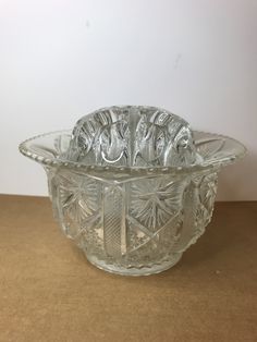 a glass bowl sitting on top of a table