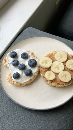 a white plate topped with banana slices and blueberries