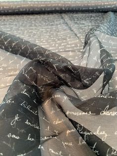 This love letters in French printed silk organza designer fashion fabric in black and off-white is a tribute to the lost art of letter writing. SKU: 8725 Content: 100% Silk Color: Black / Off-White Width: 53 inches This fabric is a last cut and no longer in production. Once sold out, we are unable to get more. Fitted White Art Silk Embroidered Fabric, Embroidered White Organza Tulle Fabric, White Embroidered Organza Tulle Fabric, Luxury White Embroidered Organza Fabric, Black And White Embroided Fabric, Off White Designer, Diy Crown, Lost Art, Print Chiffon