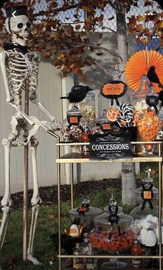 a table topped with halloween decorations and skeletons