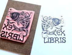 two rubber stamps with the words ex libris and an image of a fish