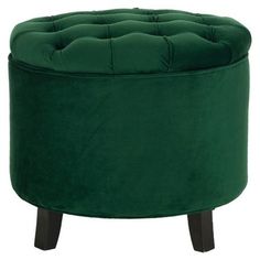 a green round ottoman with wooden legs