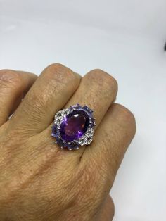 Hand made vintage deep amethyst with Purply blue natural Tanzanite and white Sapphire ring All hand made set in Sterling Silver Size 8 or 9. My jeweler can re size this for a $10 fee to any size. All rings are shipped in a nice gift box. Check out our over a THOUSAND great reviews Engraving is $4 per letter and is not always perfect depending on the piece. It can take a few days if the jeweler is busy. This is payable to Paypal Judithsltd@gmail.com Amethyst Cluster Rings With Gemstone, Amethyst Cluster Gemstone Rings, Cluster Amethyst Gemstone Rings, Amethyst Cluster Gemstone Jewelry, White Sapphire Ring, Blue Tanzanite, Natural Tanzanite, Vintage Jewels, White Sapphire