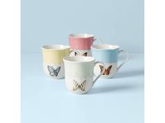 four different colored cups with butterflies on them