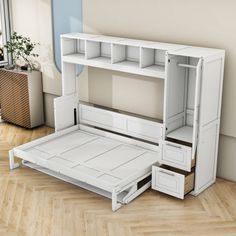 a white bed frame with drawers underneath it