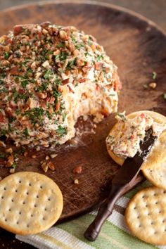 cheese ball with crackers on a wooden plate