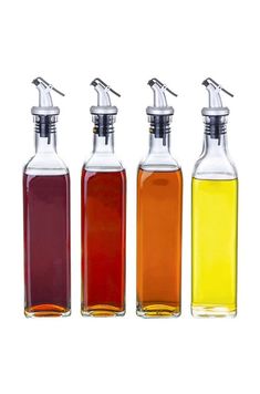 three bottles filled with different colored liquids