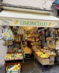 an outdoor market with lemons and other fruits