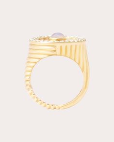 Modeled after traditional signet styles, this 14-karat gold ring decorates its circular face with signature ribbed motifs and an iridescent rainbow moonstone cabochon. Pavé-set diamonds along the outer edges create a shimmering halo effect. From Campbell + Charlotte’s Found Collection, dramatically bold designs centered around color and gemstones. 14k yellow gold, rainbow moonstone and diamond Polish with soft cloth Handmade in Thailand If you would like to consult with a fine jewelry expert, pl Ribbed Ring, Rib Ring, Halo Effect, Moonstone Cabochon, Rainbow Moonstone, Cocktail Rings, Gold Ring, Moonstone, Halo