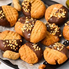 a plate full of cookies with chocolate frosting and sprinkles