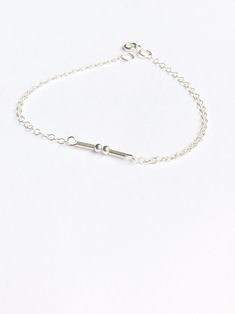 Pretty silver dot and dash beads are used to create the letter or number of your choice in Morse code - which then forms the silver bar focal element of this dainty bracelet. The Morse code letter or number could be the initial of the recipient, a loved one, a special number or a Roman numeral with a special meaning (e.g. X meaning either the number 10 or a kiss). The bracelet is for one letter or number in Morse code, additional digits may be possible depending on the number of characters neede Minimalist Sterling Silver Initials Name Bracelet, Sterling Silver Initials Bracelet, Morse Code Letters, Customised Jewellery, Initial Bracelet Silver, Black Tissue Paper, Morse Code Bracelet, Bracelet Initial, Number 10