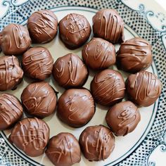 chocolate candies are arranged on a plate with blue and white design around them,