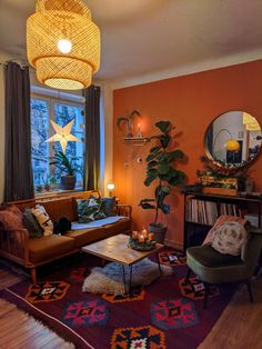 a living room filled with furniture and a star hanging from the ceiling over a fire place