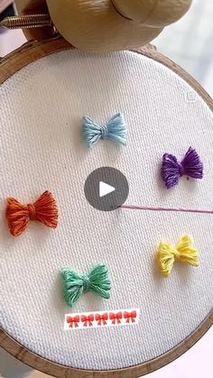 a video demonstrating how to sew bows on an embroidery hoop with needle and thread