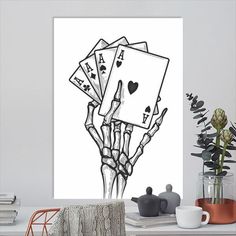 a hand holding four playing cards in it's palm