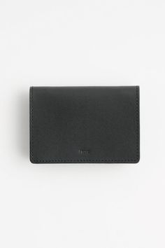 The I Ro Se mini wallet is designed using overlapping semicircles. There are 3 sections. Numbered pockets hold in "1" coins, "2" bank notes. cards, and "3" holds banknotes or cards. (Each compartment and hold about 5 cards). Bills are best inserted folded in 3 for storage. Tilt the wallet forward to to slide the coin out. Customize according to your needs. It's a great system to lighten up and to pare down your daily carry. • Handmade in Japan using Italian leather• 4" x 3" • Comes with i ro se Versatile Black Wallet With Coin Pocket, Black Wallet With Coin Pocket, Compact Black Trifold Wallet, Luxury Black Compact Trifold Wallet, Daily Carry, Black Rectangular Wallet For On-the-go, Belt Jewelry, Mini Wallet, Fold Wallet