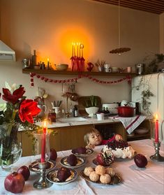 a table topped with lots of food and candles