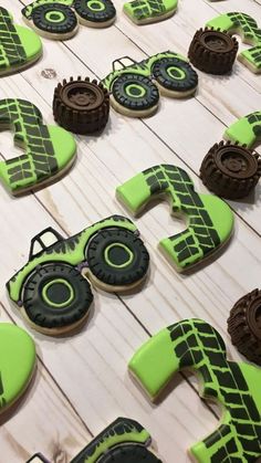 decorated cookies are arranged in the shape of numbers and tractor wheels on a wooden table