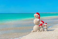 a snowman and two small children on the beach