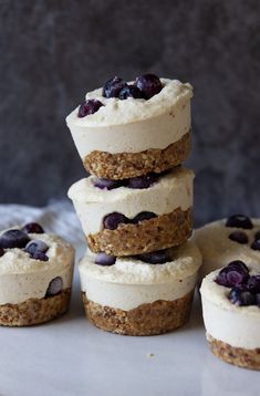 there are several small cupcakes stacked on top of each other with blueberries