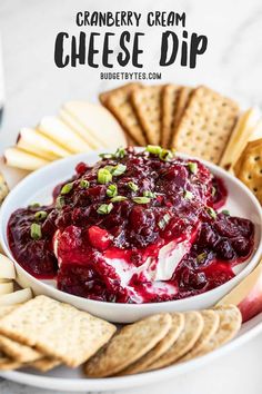 cranberry cream cheese dip on a plate with crackers