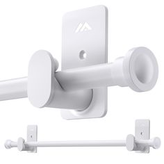 an image of a white wall mount with two hooks on the back and one hook attached to it