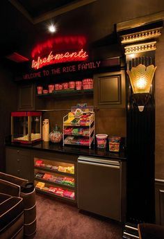 the interior of a deli with neon signs on the wall and lights above it