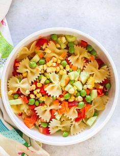 a white bowl filled with pasta and vegetables