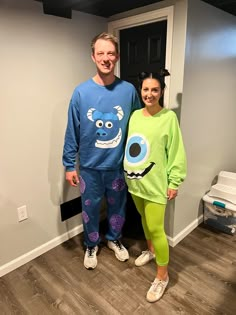 a man and woman in pajamas standing next to each other