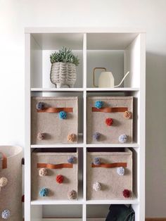 a white book shelf filled with lots of crafting supplies