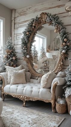 a living room decorated for christmas with white furniture and wreaths on the mirror wall