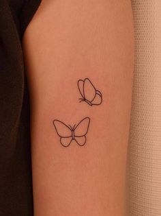 two butterflies tattoo on the arm