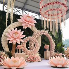 an elaborately decorated stage with pink flowers and chandeliers