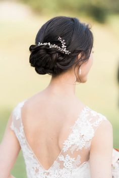 the back of a woman's head wearing a wedding dress