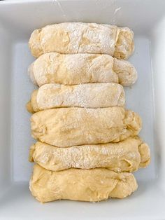 a pile of dough sitting in a white bowl