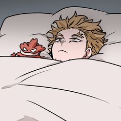 a man laying in bed next to a stuffed animal